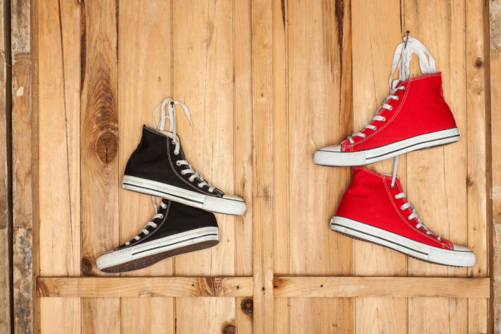 Vibrant red and black shoes hanging behind the door