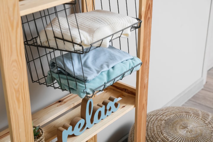 A metallic hanging organizer with multiple shelves 