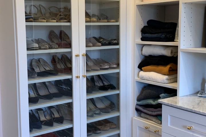 Custom ShelfGenie shelving holding shoes in a closet 