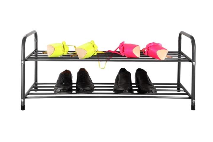 A black shoe rack featuring two tiers that can store up to 12 pairs of shoes each 