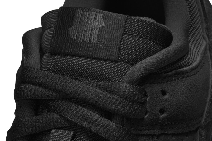 black undefeated dunks on feet