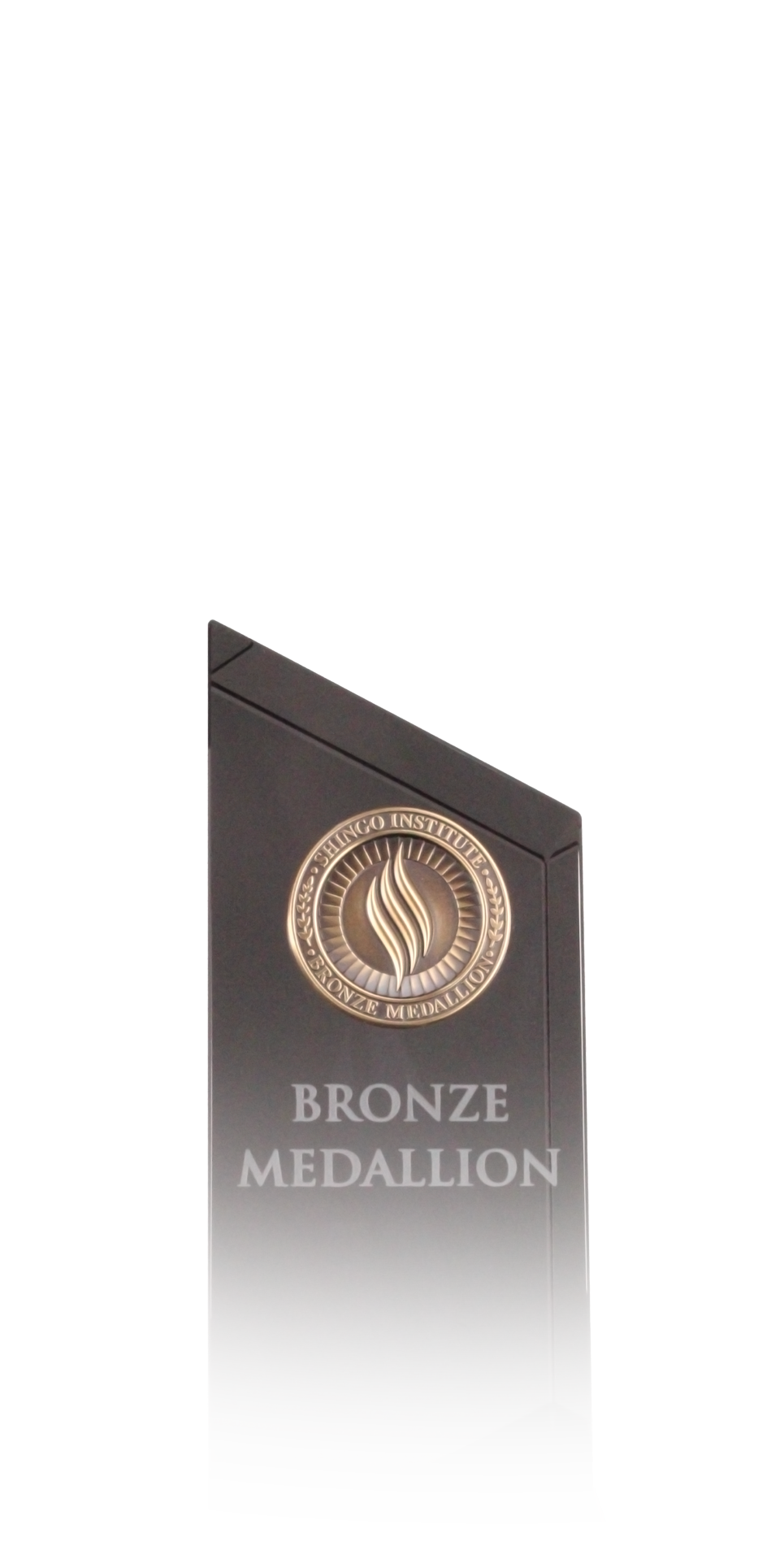 Bronze metal medallion embossed with the text "Shingo Medallion, Bronze, Operational Excellence"