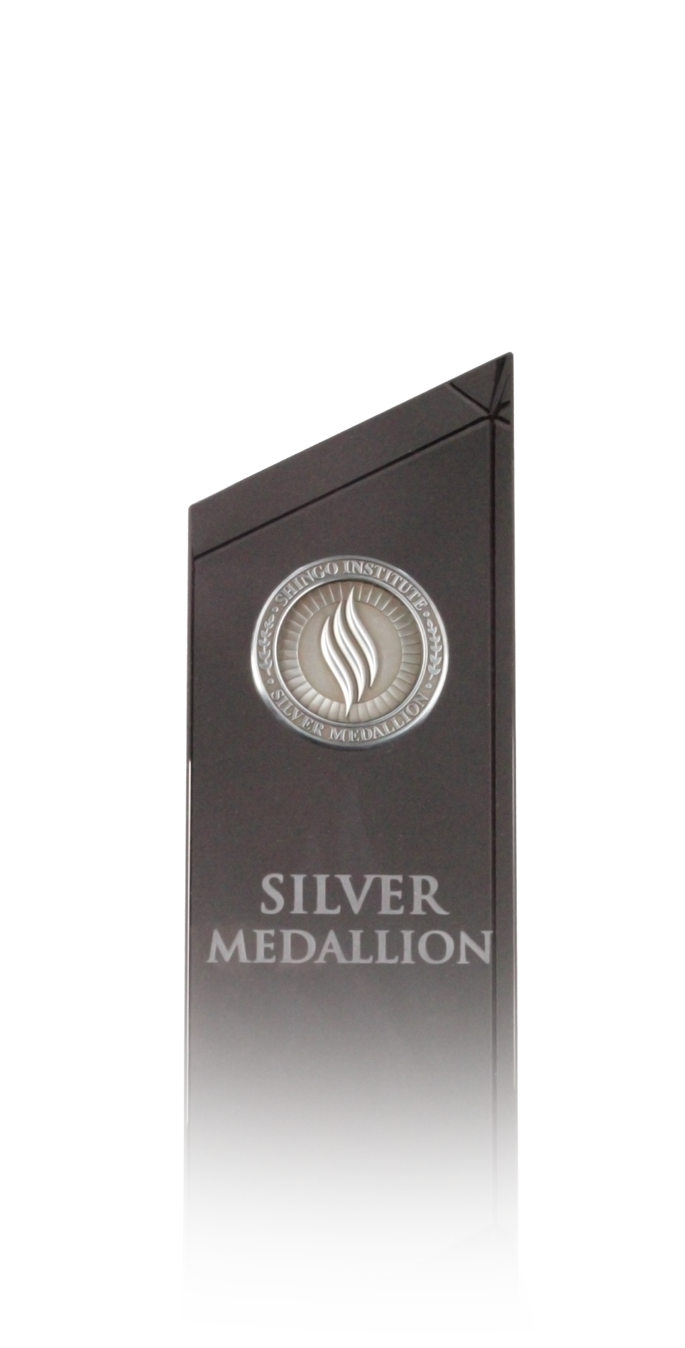 Silver metal medallion embossed with the text "Shingo Medallion, Silver, Operational Excellence"