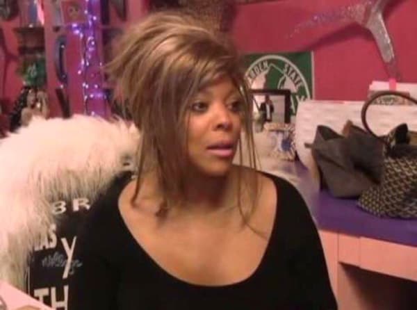 Wendy Williams looks disheveled, as though she is adjusting to waking up.