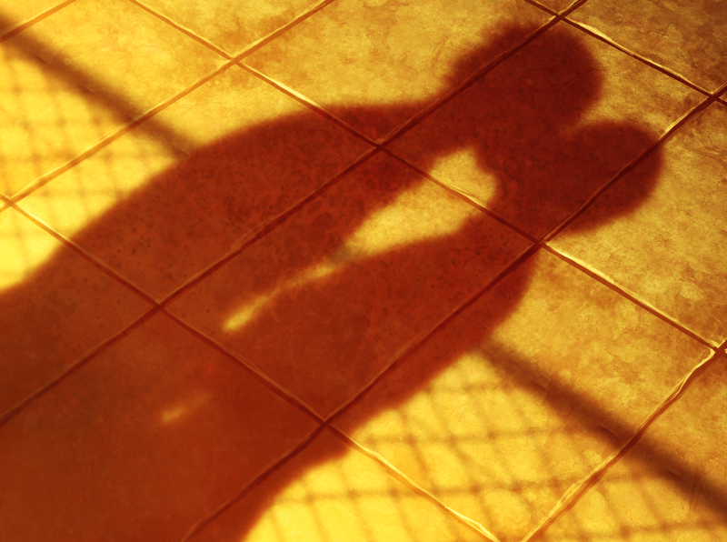 Shadows of Youji and Tetsuo kissing cast on the surface of the roof.