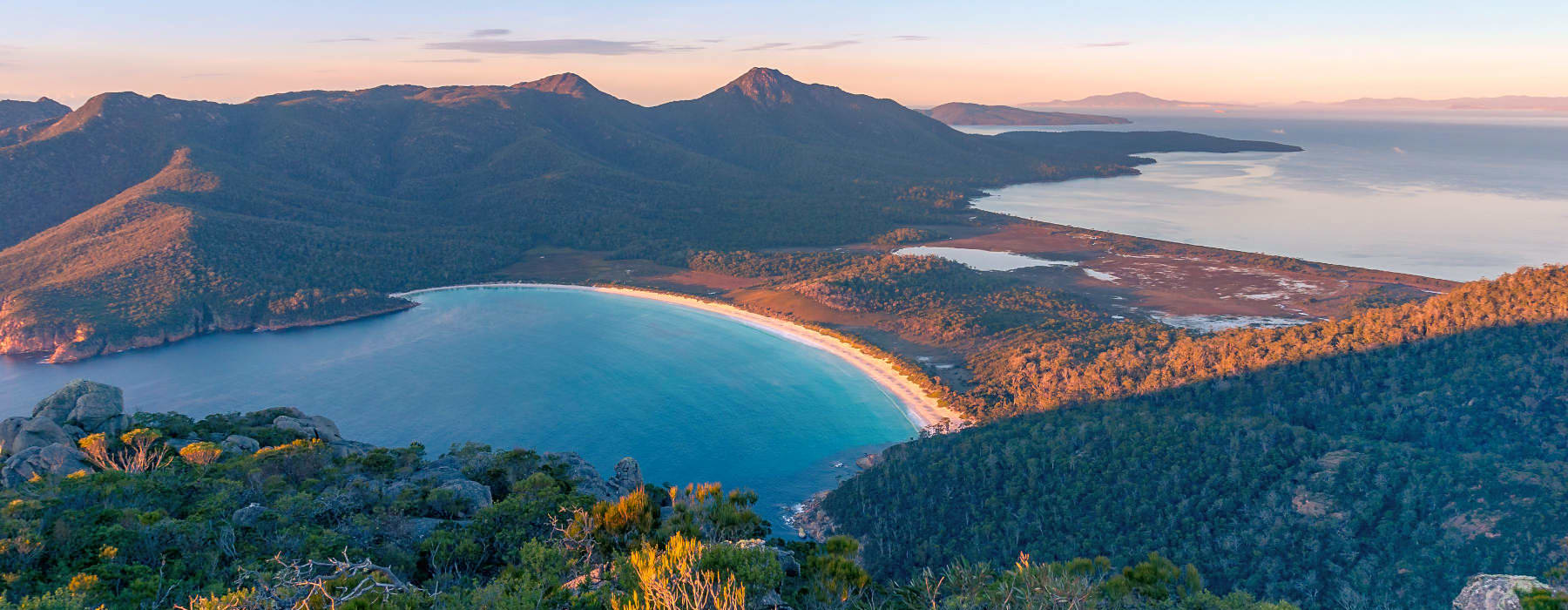 Sunrise nature landscape of beautiful bay and mountains in Tasmania after removals to Hobart