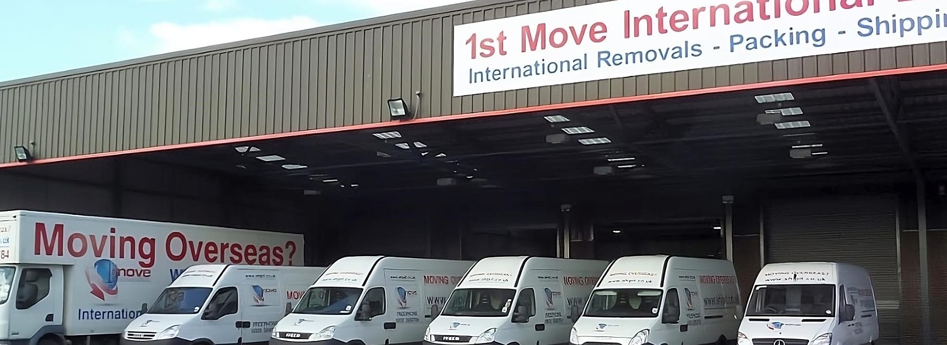 1st Move International removal vans lined up outside the company's warehouse and headquarters