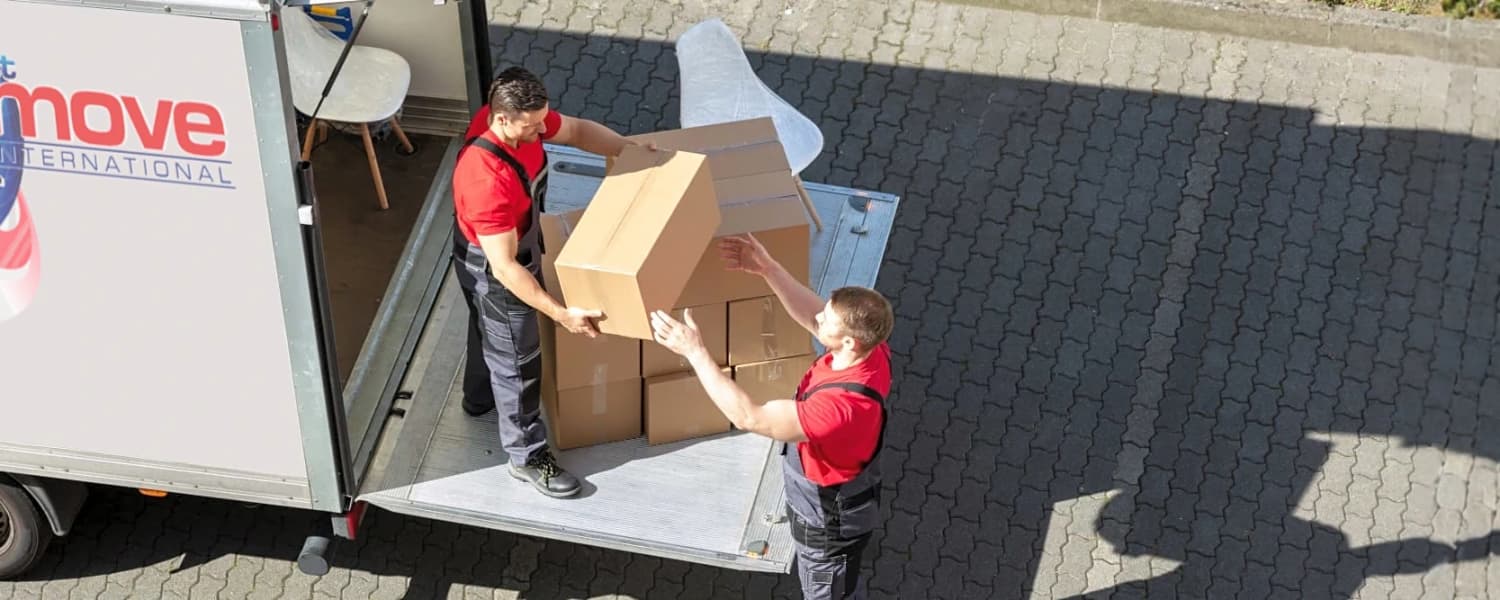 2 men packing the 1st Move International van with a customers personal effects