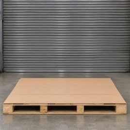 Empty wooden pallet covered with a heavy-duty cardboard base.