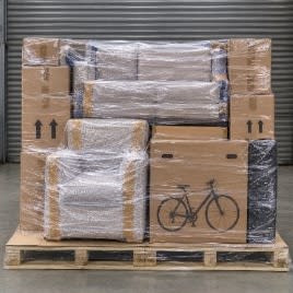 Wrapped furniture and cartons built tightly onto a pallet and held together with clear stretch film.