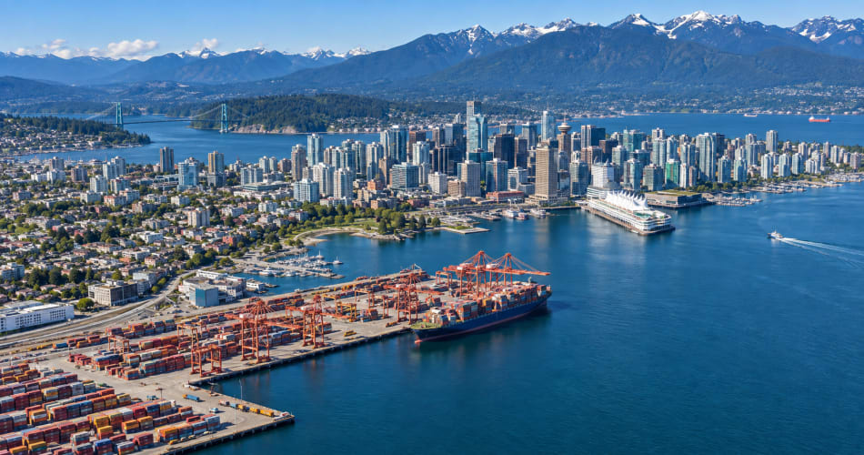 Aerial view of Vancouver Harbour, Canada Place and the container terminal with the North Shore Mountains beyond.