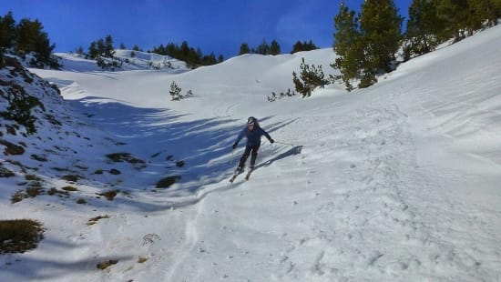 Skiing down through the forests to La Piuca