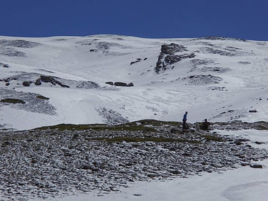 Putting on skies. Route goes left of prominent prow of rock