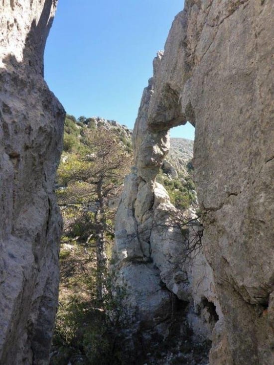 Descending past the rock arch