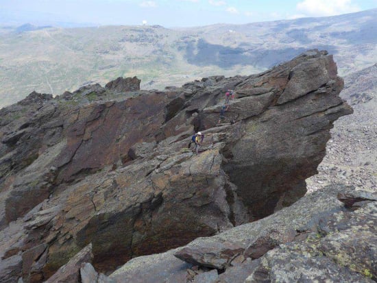 Trying to figure out how to get down the step, Felipe setting up the abseil point