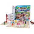 The Horse Academy game setup in front of the game box. The box cover shows the game in play with trees and a stable in the background. The instruction booklet is leaning up against the box, showing an expert challenge. In front, is the gameboard. It is a sand-colored rectangle with white fence pieces around the edges. There a several jumping fence pieces in many colors. Off the board, on either side is another jumping fence piece and a red girl character on top of a horse piece.