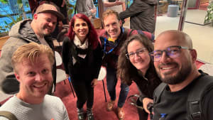 Six people in a selfie from a tech conference