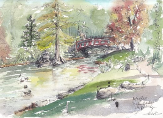Watercolor and ink sketchbook page of a small river in a piney forest with a red bridge in the background. A path winds along the riverbank toward the viewer