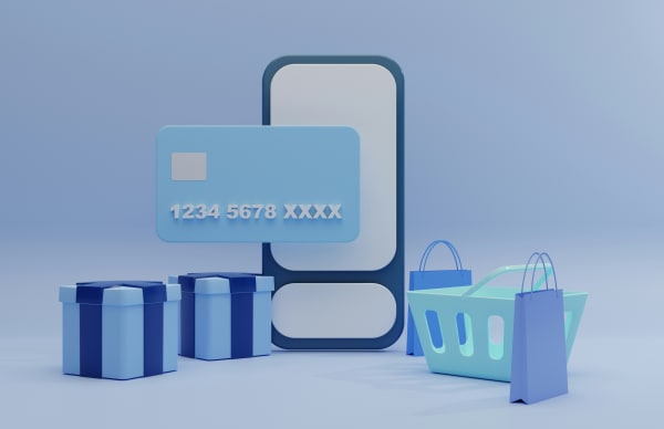A mobile phone with a credit card, give boxes, shopping hand basket around it