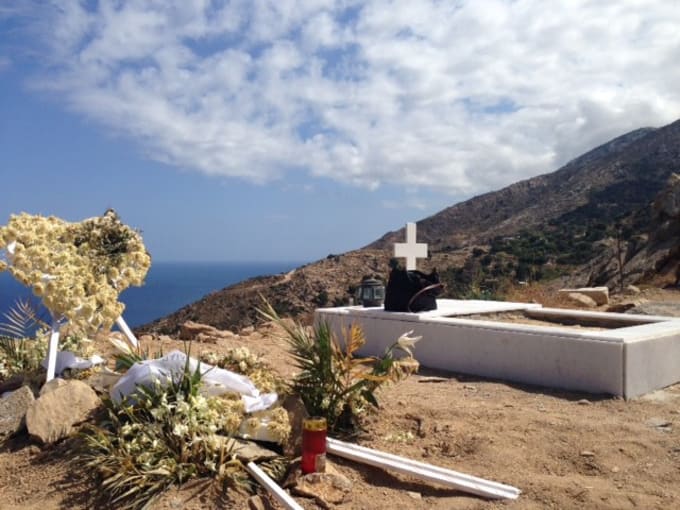 Two graves on a mountain overlooking the Aegean Sea, one fresh