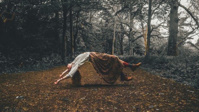 Woman in woods levitating