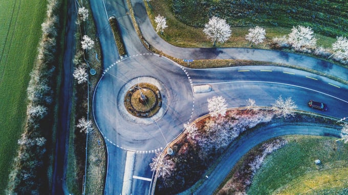 View of a roundabout from above surrounded by trees