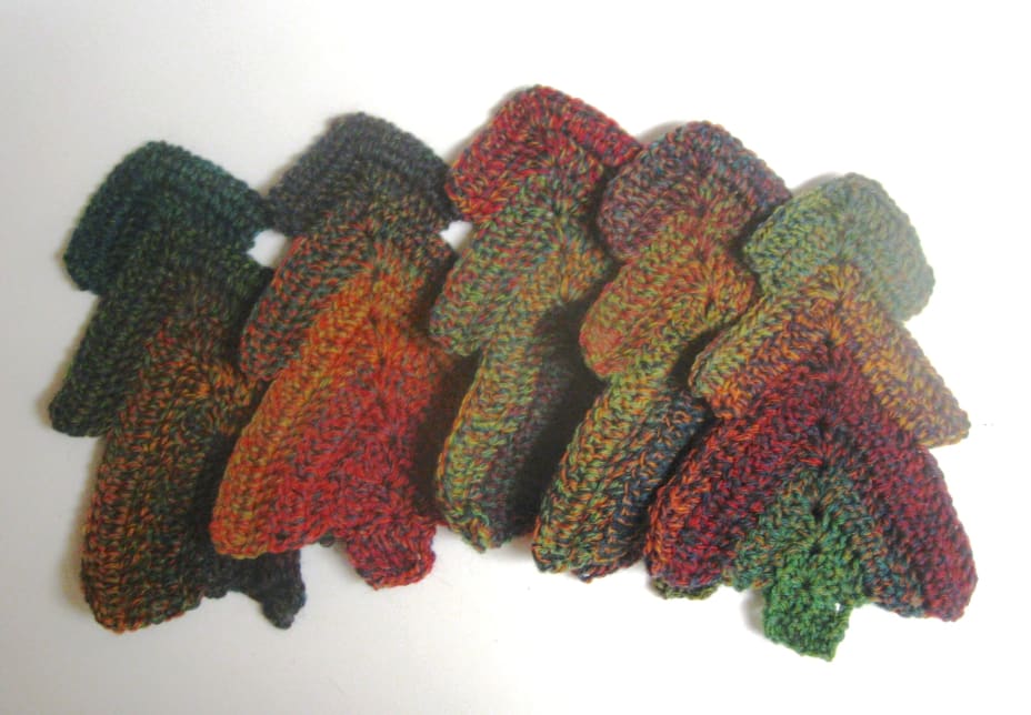 Crochet Christmas trees in a variegated green-red-yellow yarn