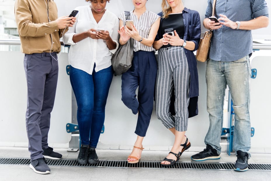 Group of people all together but only looking at their phones