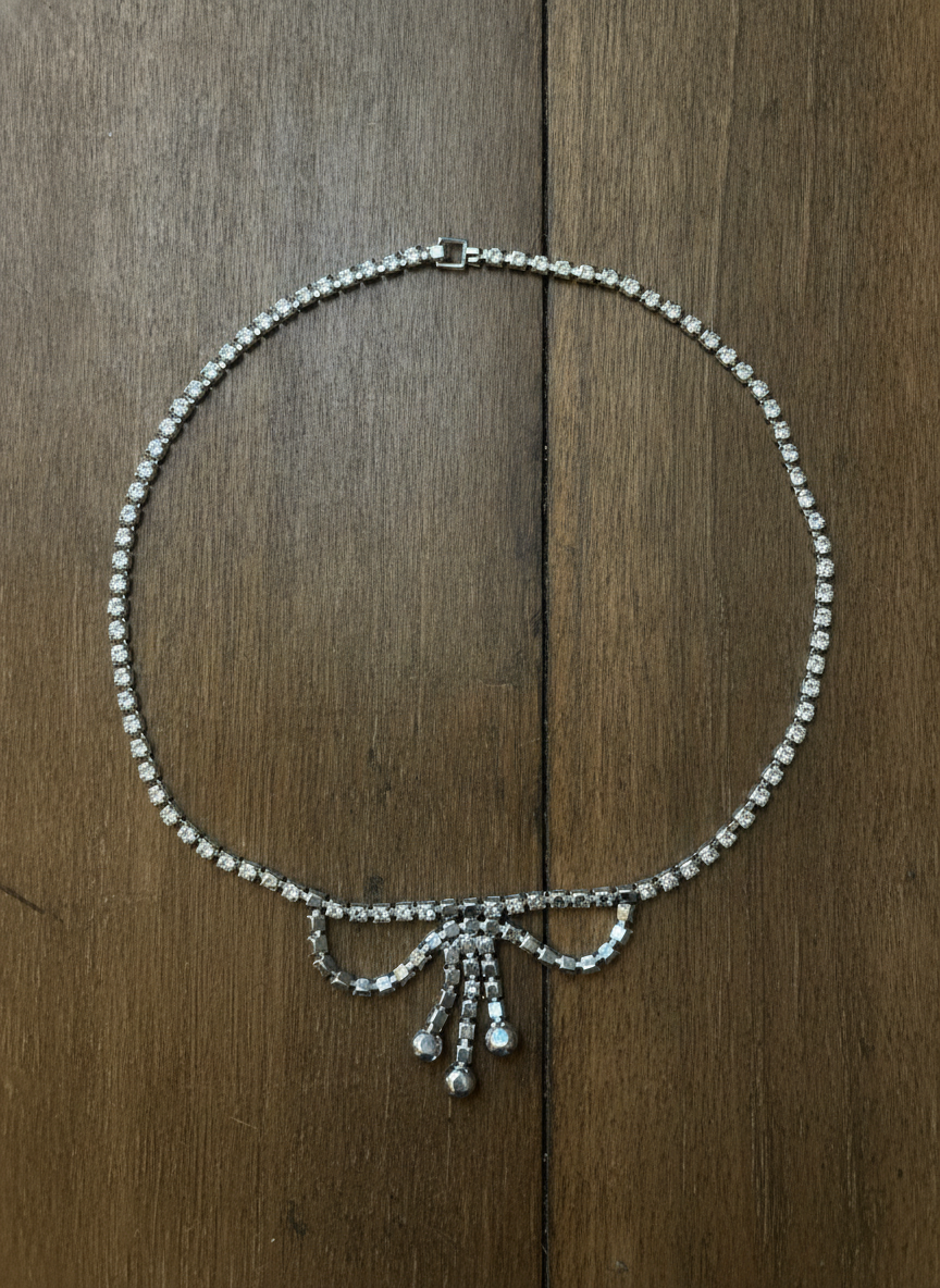 Elegant Rhinestone Bow Necklace - Styled Flat-Lay