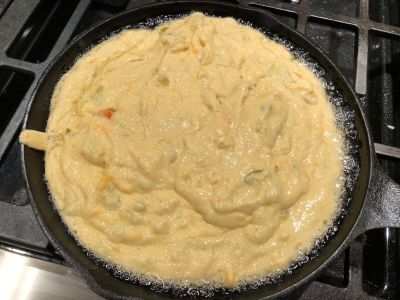 Add the Batter to the Hot Pan (Note the bubbling of the oil around the outside)