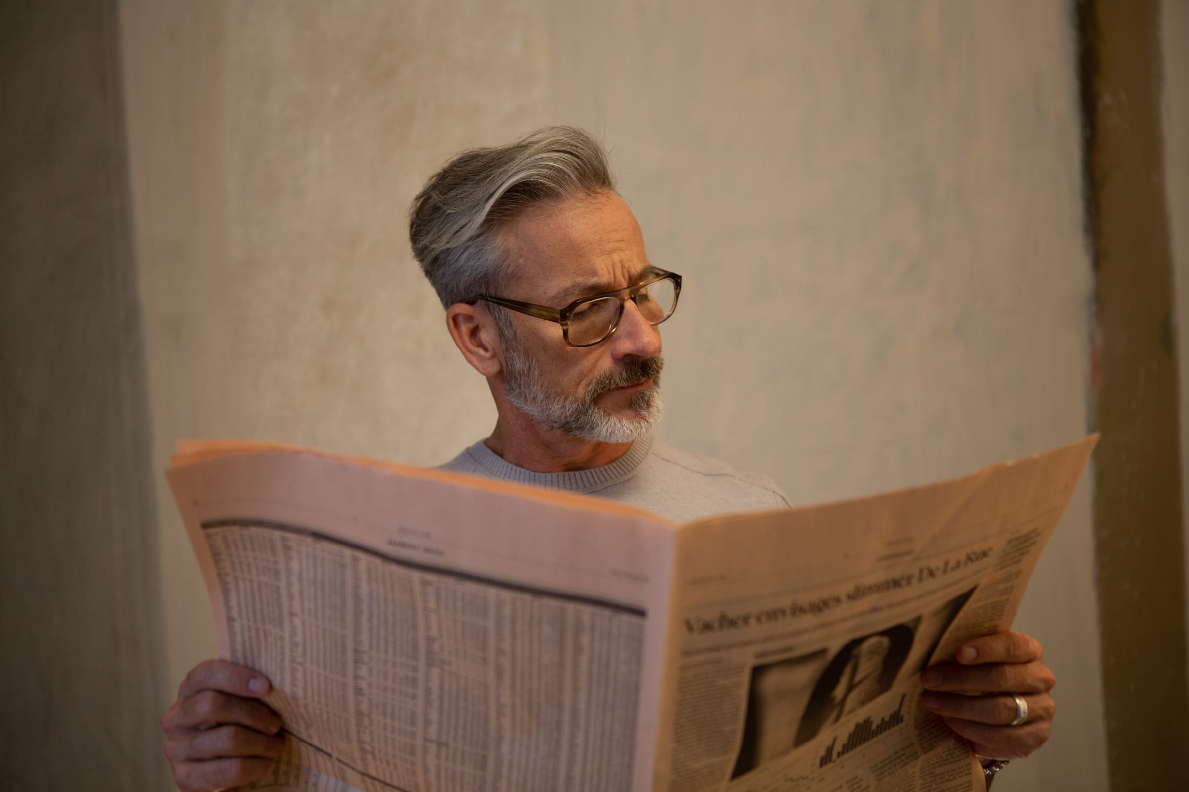 Art husband reading the newspaper in his home at 180 E 88th Street, a luxury condominium in the Upper East Side of Manhattan