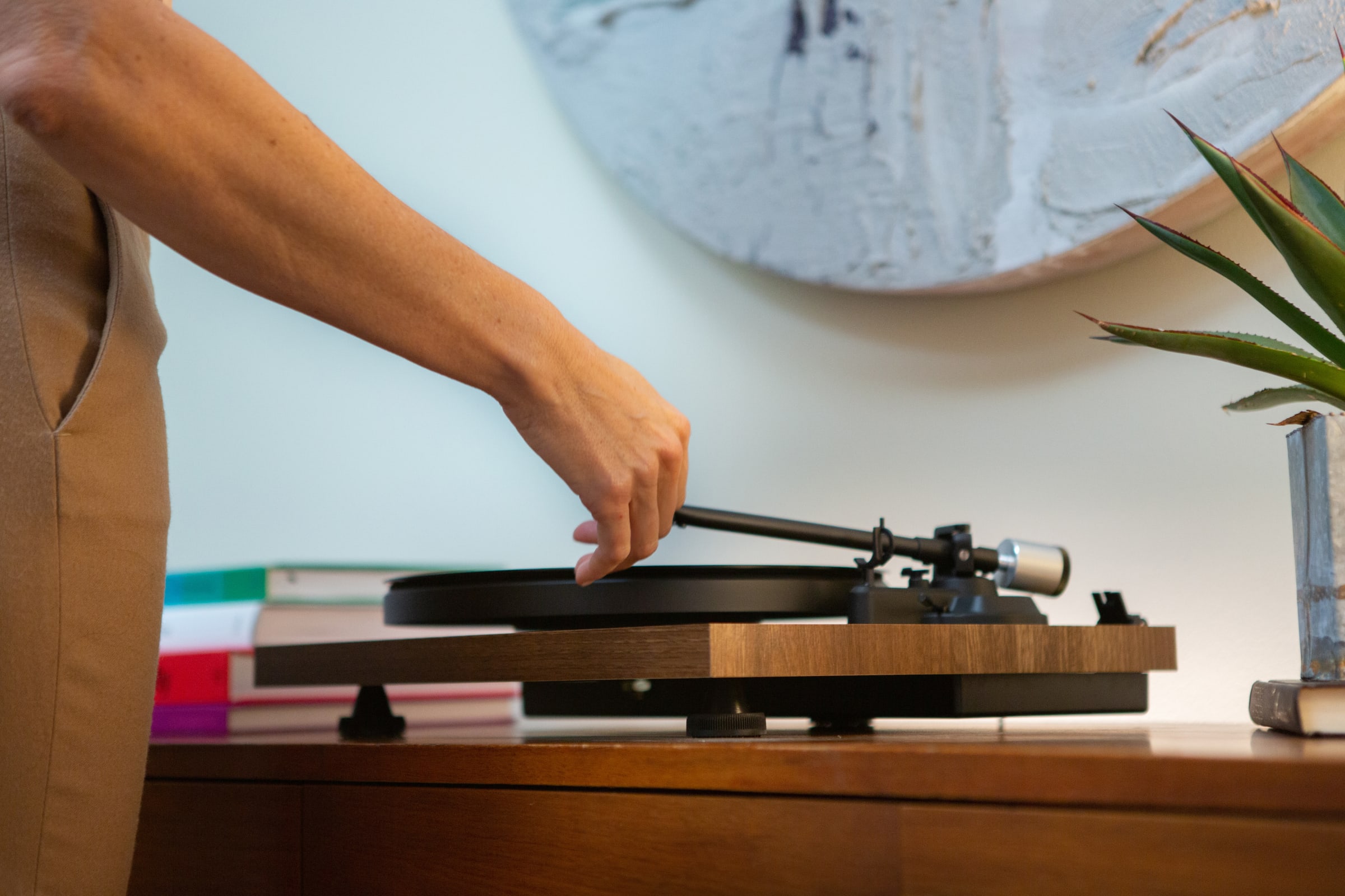 Art wife's hand playing a record in her home at 180 E 88th Street, a luxury condominium on the upper east side of Manhattan