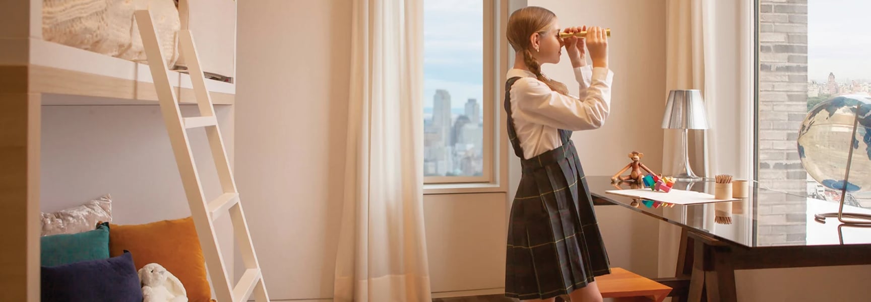 180 E 88th street luxury condo with girl looking out window through binoculars, photoshoot produced by Sideways Creative Branding agency