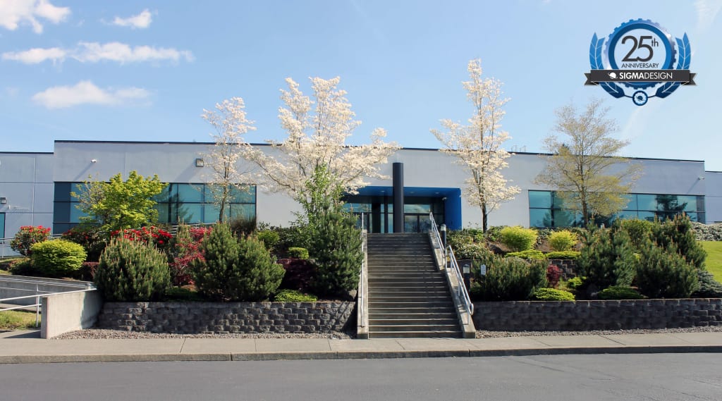 front of SIGMADESIGN headquarters building with trees in bloom