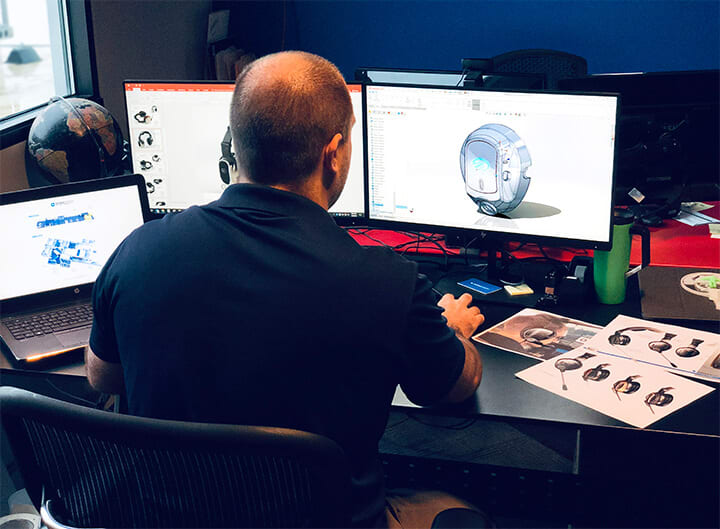 Image of Patrick Scranton bringing a sketch to life at his desk