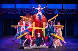 Grace Yoo (Hillary Clinton, center) and the cast of Soft Power at Signature Theatre. Photo by Daniel Rader.