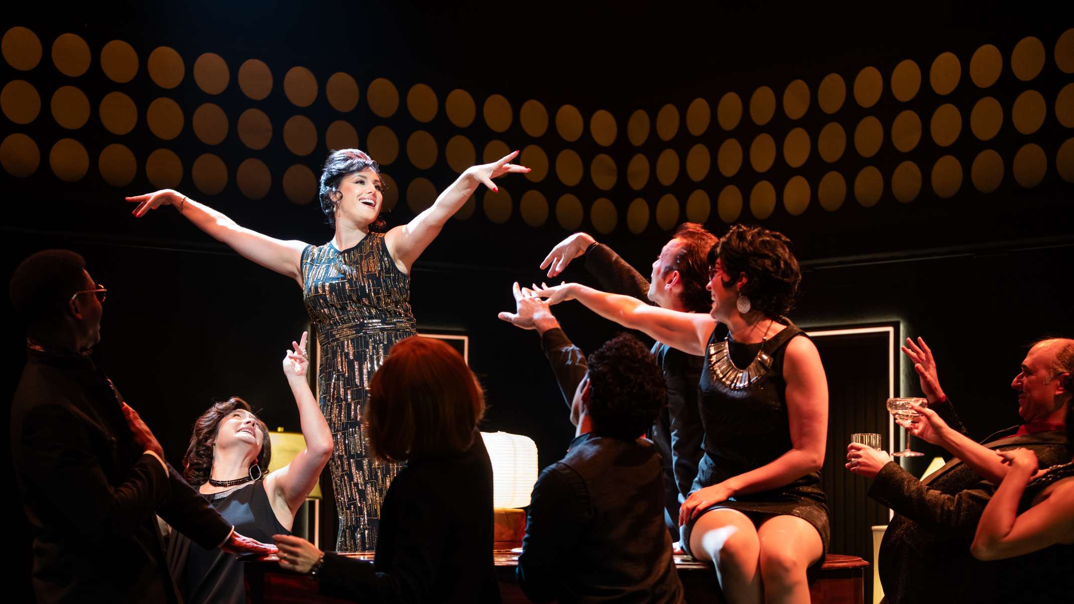 Maria Rizzo (Gussie Carnegie) and the cast of Merrily We Roll Along