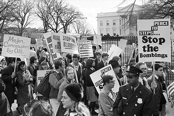 Protestors holding signs that read 