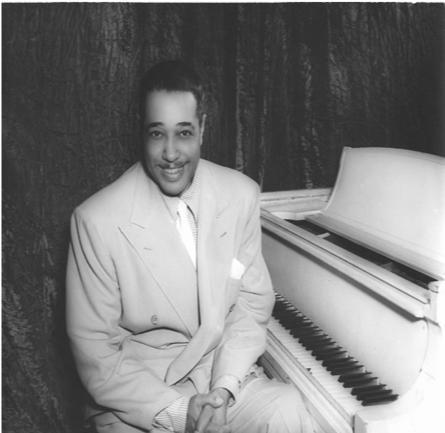 Duke Ellington sits at a piano at the Howard Theatre