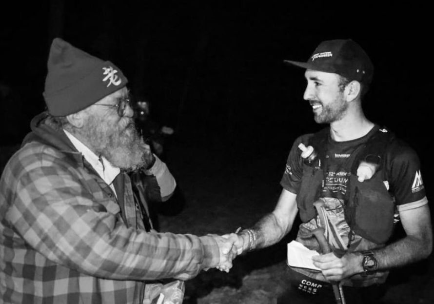 5 Ultra-Cool Ways to Geek Out About the 2023 Barkley Marathons - Barkley Marathons race director and founder Lazarus Lake shakes hands with first-place finisher Aurélien Sanchez. Photo credit: Ultrarunning History.