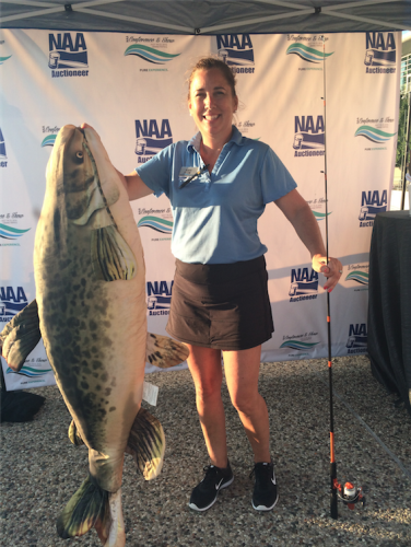Amy Young holding fish in photo booth in Grand Rapids