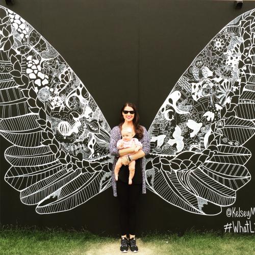 Woman with infant posing beside art during ArtPrize in Grand Rapids
