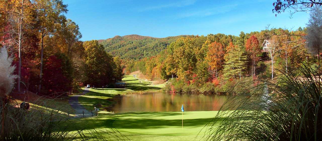 Fall color backdrop at Rumbling Bald Golf Course}