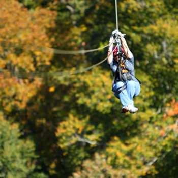 Riding a Zipline during Fall in Asheville