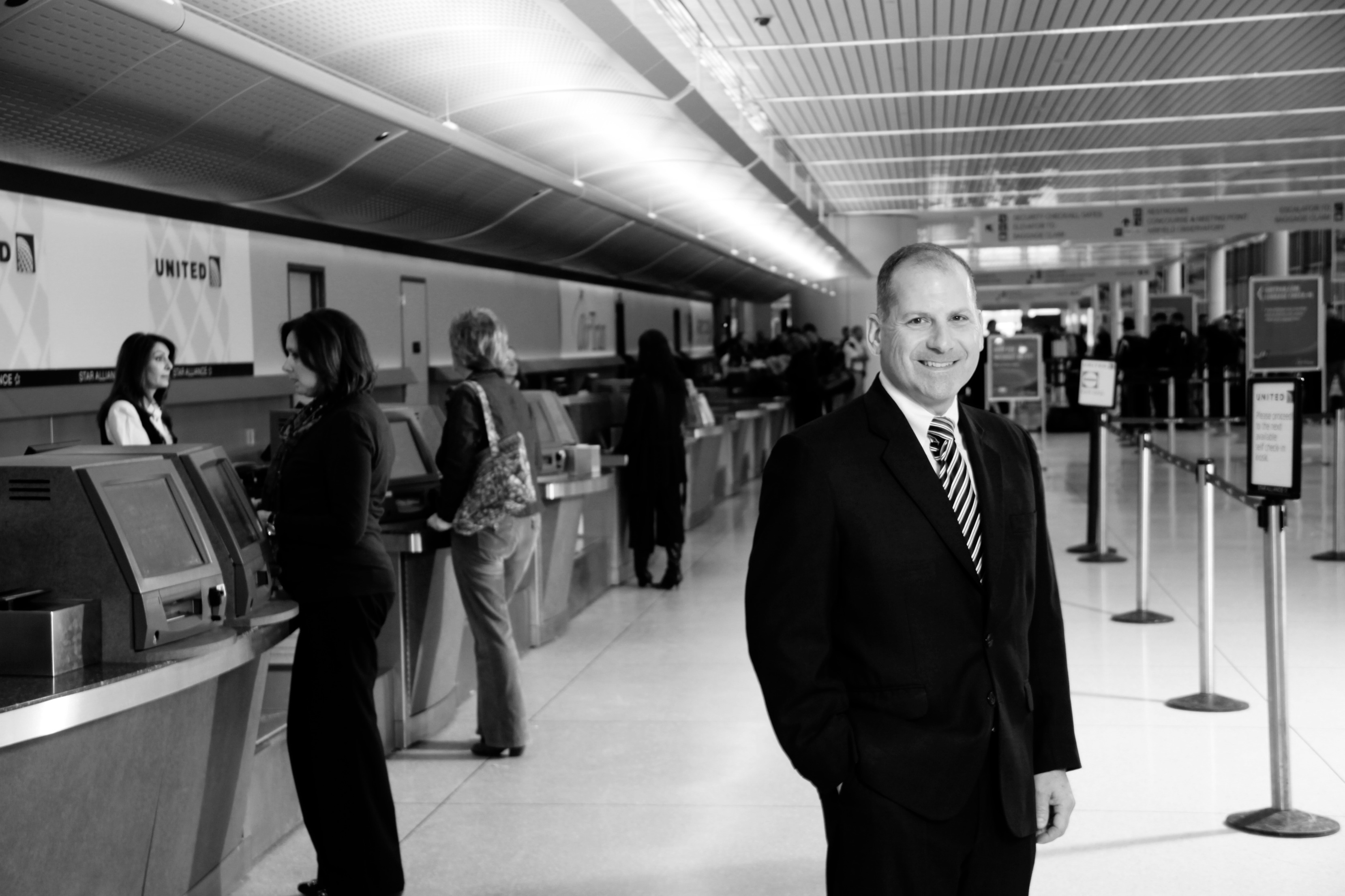 Mike stands in the Airport terminal