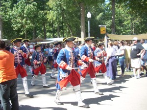 Drum & Fife Corps march through the festival grounds.