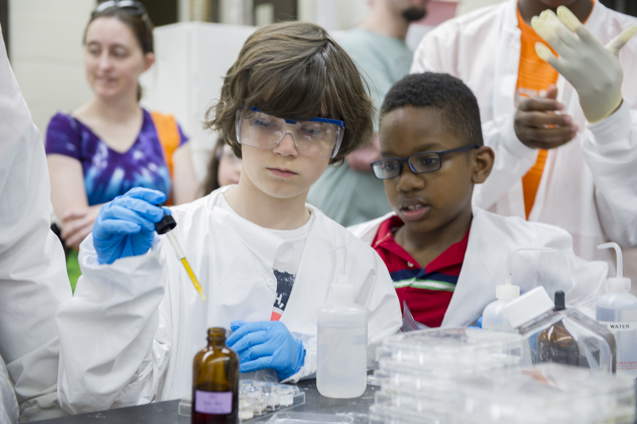 Kids in lab coats get into science experiments at Imagine RIT Festival