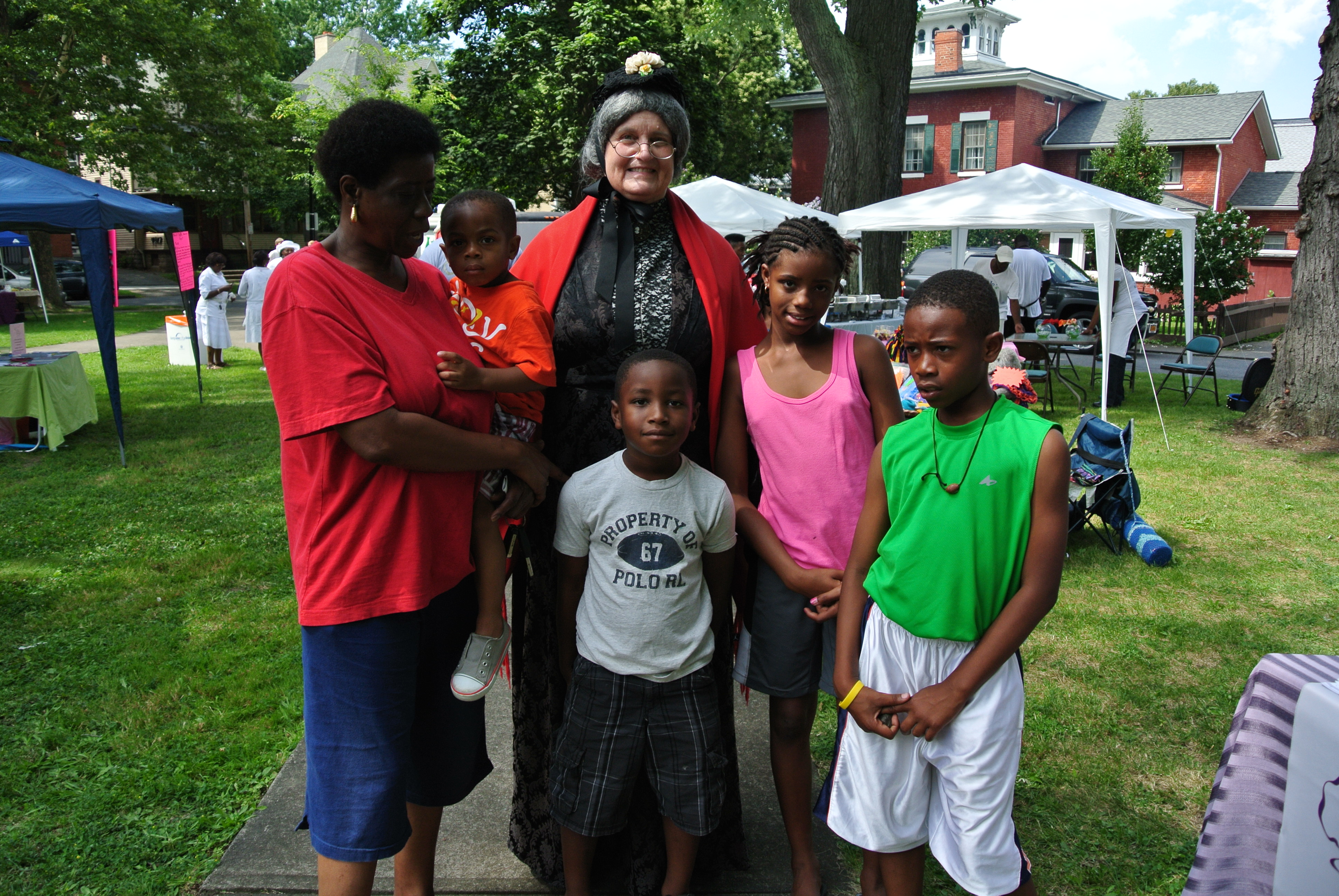 a family poses for a picture with Susan B. Anthony