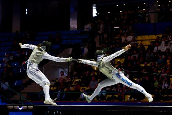 two youth fence on stage