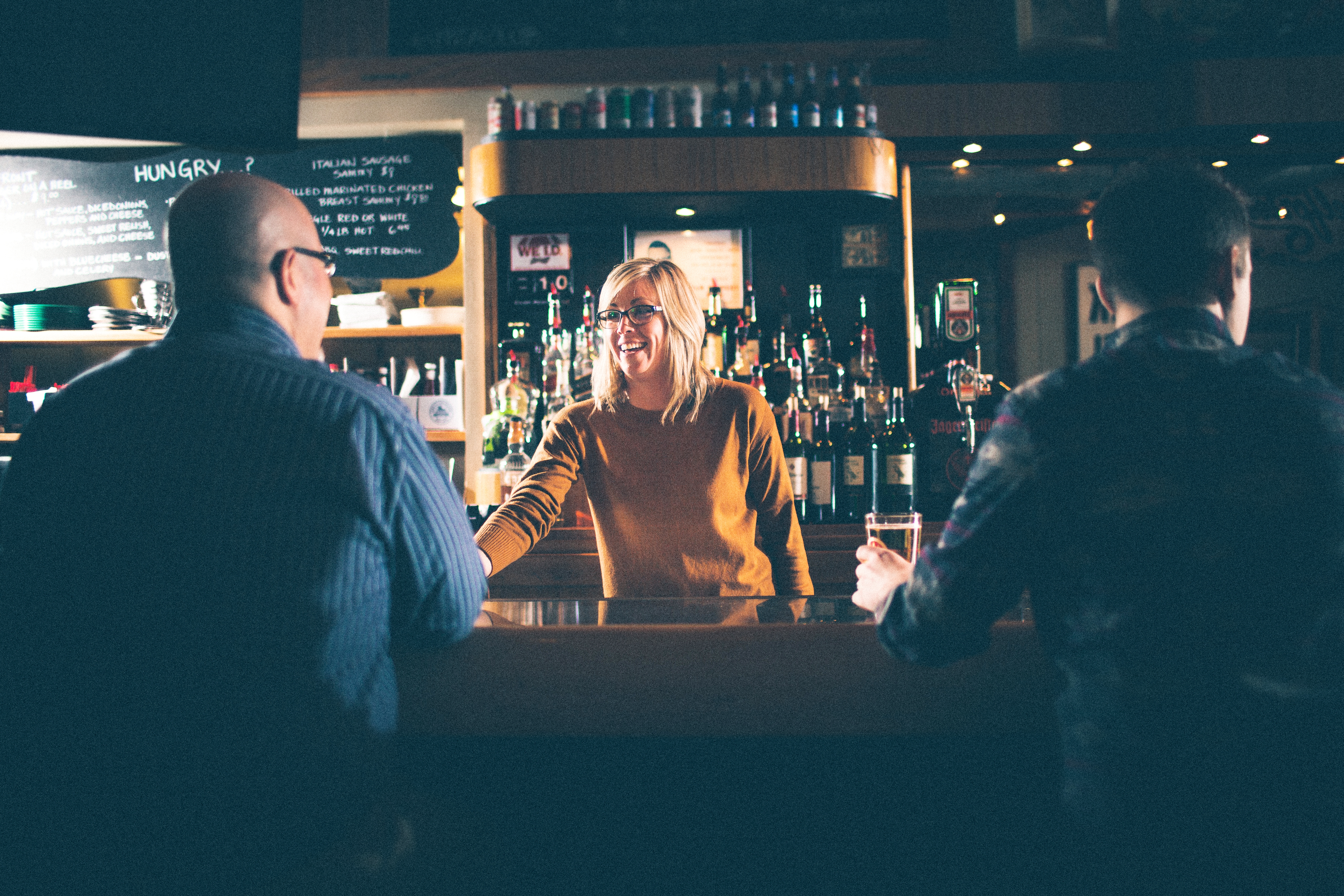 Bartender serving patrons at The Green Front in Canandaigua